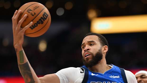 Mavericks center JaVale McGee grabs a rebound.
